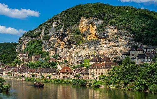 Mountain with houses in front of it and lake in Northern Italy.